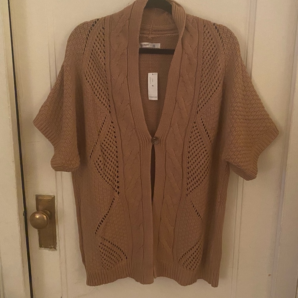 Button front short sleeved sweater vest.